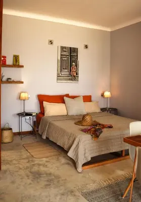 a bedroom with a bed and two tables and two lamps at Leben am Atlantik hautnah spüren in Sal Rei
