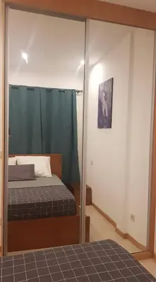 a bedroom with a bed and a mirror at Casa JPi in São Pedro