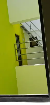 a staircase in a room with a green wall at Casa JPi in São Pedro