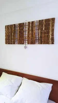 a headboard of a bed with a white pillow at Casa JPi in São Pedro