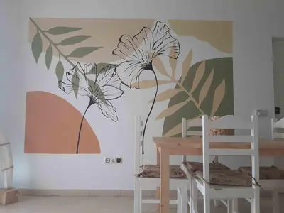 a wall mural of flowers on a wall at AMA Apartament Ponta Preta in Calheta Do Maio