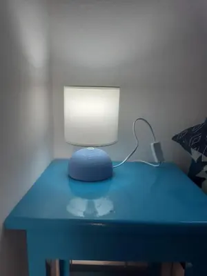 a blue desk with a lamp on top of it at AMA Apartament Ponta Preta in Calheta Do Maio