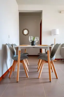 a dining room with a table and chairs at Brand New Chic Appt in Mindelo at Great Rates in Mindelo