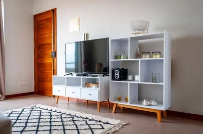 a white entertainment center with a flat screen tv at Brand New Chic Appt in Mindelo at Great Rates in Mindelo