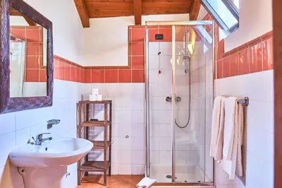 a bathroom with a shower and a sink at Patio Antigo Residence in Santa Maria
