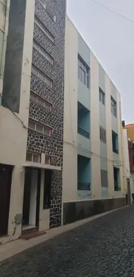 a building with lots of windows on a street at Residencial Bibi in Ribeira Grande
