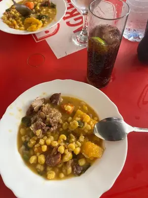 a plate of food with a bowl of soup on a table at Apartamento Os Bidons in Praia