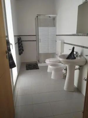 a bathroom with two toilets and a sink and a shower at Zodiaco Apartments in Sal Rei