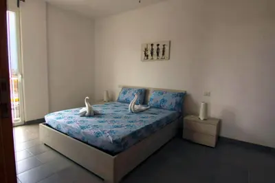 a bedroom with a bed with two white birds on it at Zodiaco Apartments in Sal Rei