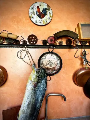 a wall with a sink with a clock and other items at Casa de Poço Guest House and Gallery in Mindelo