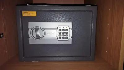 a black tv with a remote control in it at Sol Hotel in Praia