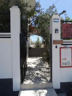 an entrance to a building with a gate and a sign at Yria Residencial in Porto Novo