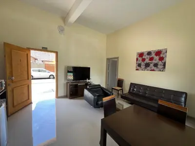 a living room with a couch and a television at Praia Capital Residence Aparthotel in Praia