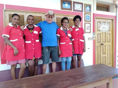 a man standing next to a group of girls at Edificio Magico in Tarrafal