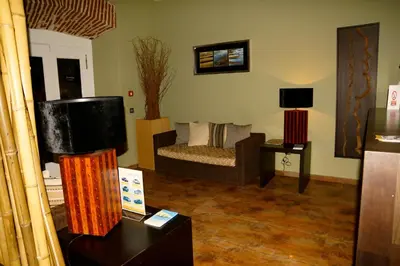 a living room with a couch and a television at Hotel Praia Confort in Praia