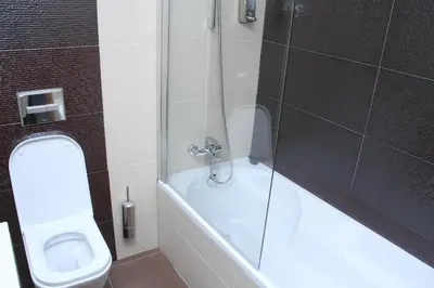 a bathroom with a shower and a toilet and a tub at Hotel Praia Confort in Praia