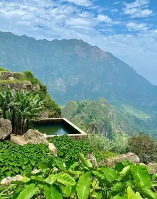 a swimming pool on a hill with mountains in the background at Pam de Terra in Palha Carga