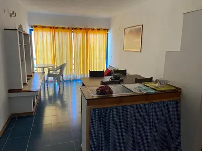 a kitchen and living room with a counter and a table at Beach Rotxa in Vila do Maio