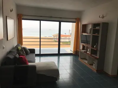 a living room with a couch and a view of the ocean at Beach Rotxa in Vila do Maio