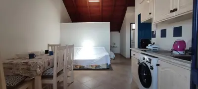 a kitchen with a table and a sink and a room at Sal Service new studio penthouse in Santa Maria