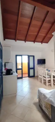 a kitchen and living room with a table and chairs at Sal Service new studio penthouse in Santa Maria