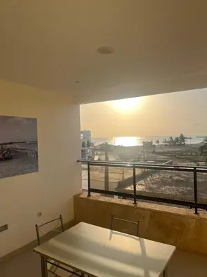 a room with a table and a view of the beach at Apartamentos Santiago - Maio in Vila do Maio