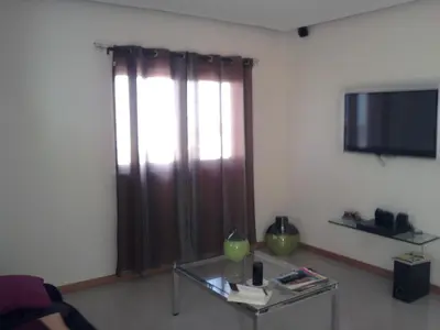 a living room with a glass table and a large window at Apartamentos Santiago - Maio in Vila do Maio