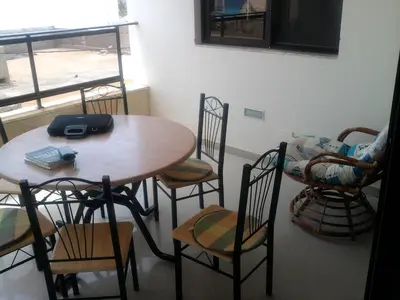 a table and chairs in a room with a window at Apartamentos Santiago - Maio in Vila do Maio