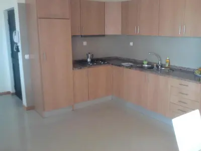 a kitchen with wooden cabinets and a sink at Apartamentos Santiago - Maio in Vila do Maio