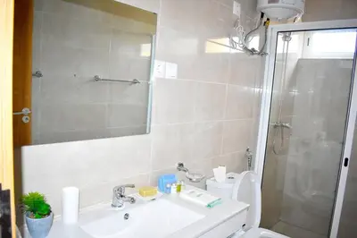 a bathroom with a toilet and a sink and a shower at Lovely - Luxury 2 Bedrooms 500m from the Beach in Santa Maria