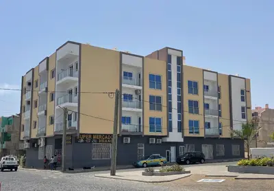 a yellow car parked in front of a building at Lovely - Luxury 2 Bedrooms 500m from the Beach in Santa Maria