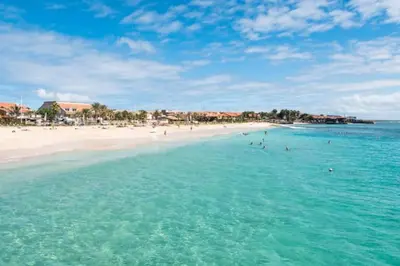 a beach with a group of people in the water at Time Out Pátio Antigo AC Wifi in Santa Maria