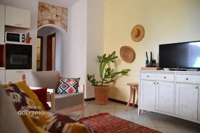a living room with a flat screen tv on the wall at BookingBoavista - Apartments in Sal Rei