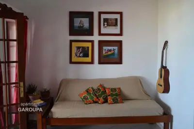 a living room with a couch and a guitar at BookingBoavista - Apartments in Sal Rei