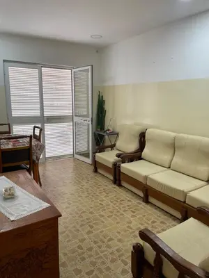 a living room with a couch and a table at Apartamentos Avenida in Praia