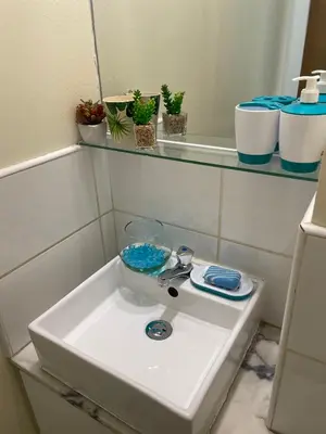 a bathroom sink with a bowl on top of it at Apartamentos Avenida in Praia