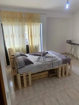 a wooden bed in a room with a window at Appart Hotel Belvedere in Praia