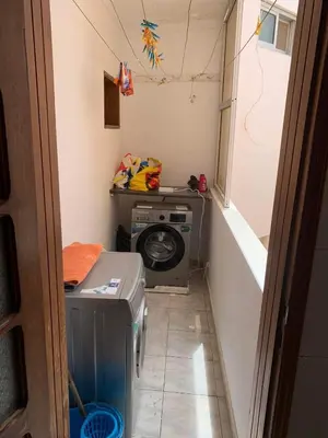 a small laundry room with a washing machine in it at Appart Hotel Belvedere in Praia