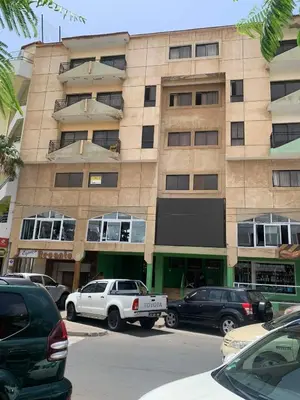 a large building with cars parked in front of it at Appart Hotel Belvedere in Praia