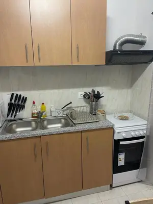 a kitchen with a sink and a stove at Apartamento Vila Santa Bárbara ,Bloco F RChão Dirt,Santo Antão,Cabo Verde in Mão para Trás