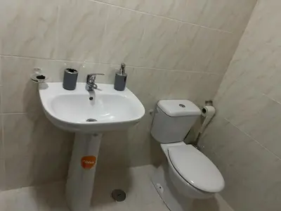 a bathroom with a toilet and a sink at Apartamento Vila Santa Bárbara ,Bloco F RChão Dirt,Santo Antão,Cabo Verde in Mão para Trás