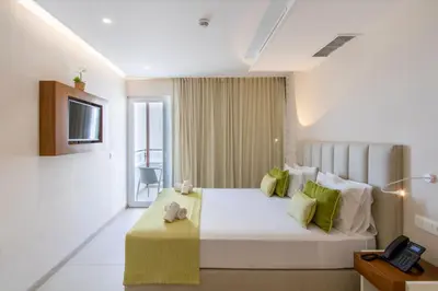 a hotel room with a bed and a television at Luna Boutique Hotel in Mindelo