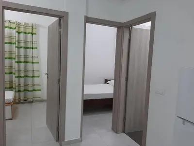 a room with a bedroom with a bed and a mirror at Núria's Apartment in Mindelo
