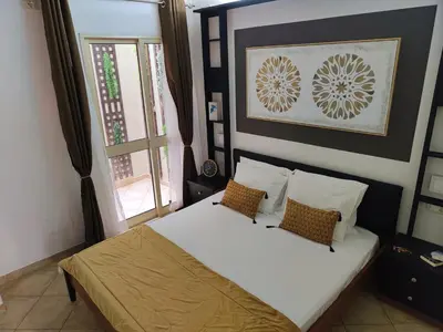 a bedroom with a bed with two pillows and a window at Cacau's Home - By Albis Harena in Santa Maria