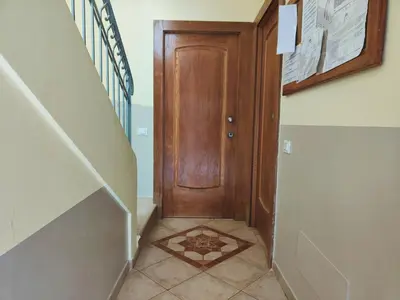 a hallway with a wooden door and a tile floor at Cacau's Home - By Albis Harena in Santa Maria