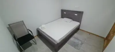 a small bedroom with a bed and a mirror at Helton´s Residence in Praia