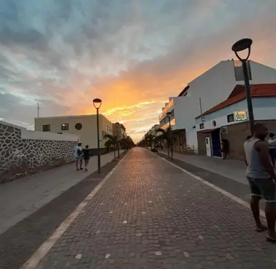 a cobblestone street with a sunset in the background at Relaxed Home to calm in Santa Maria