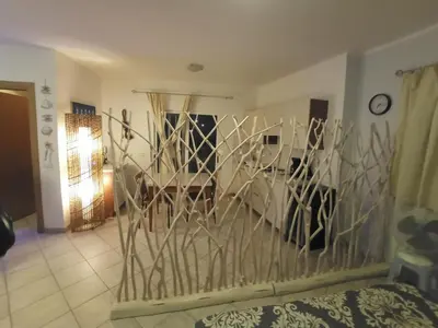 a living room with a bed and a wall of mirrors at Relaxed Home to calm in Santa Maria