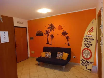 an orange room with a chair and a surfboard at Relaxed Home to calm in Santa Maria