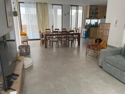 a living room with a couch and a table and chairs at Kyaala Suítes - pool & sea view in Praia